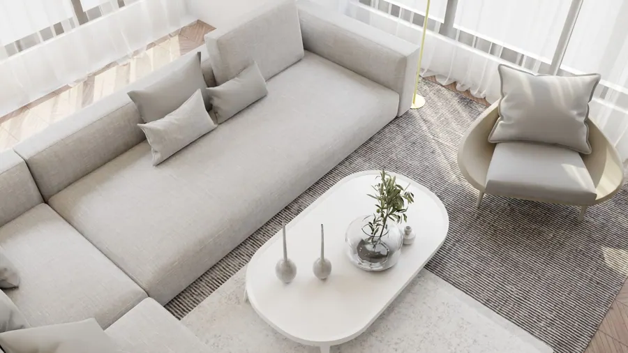 Lichte bank en ronde salontafel in een witte kamer